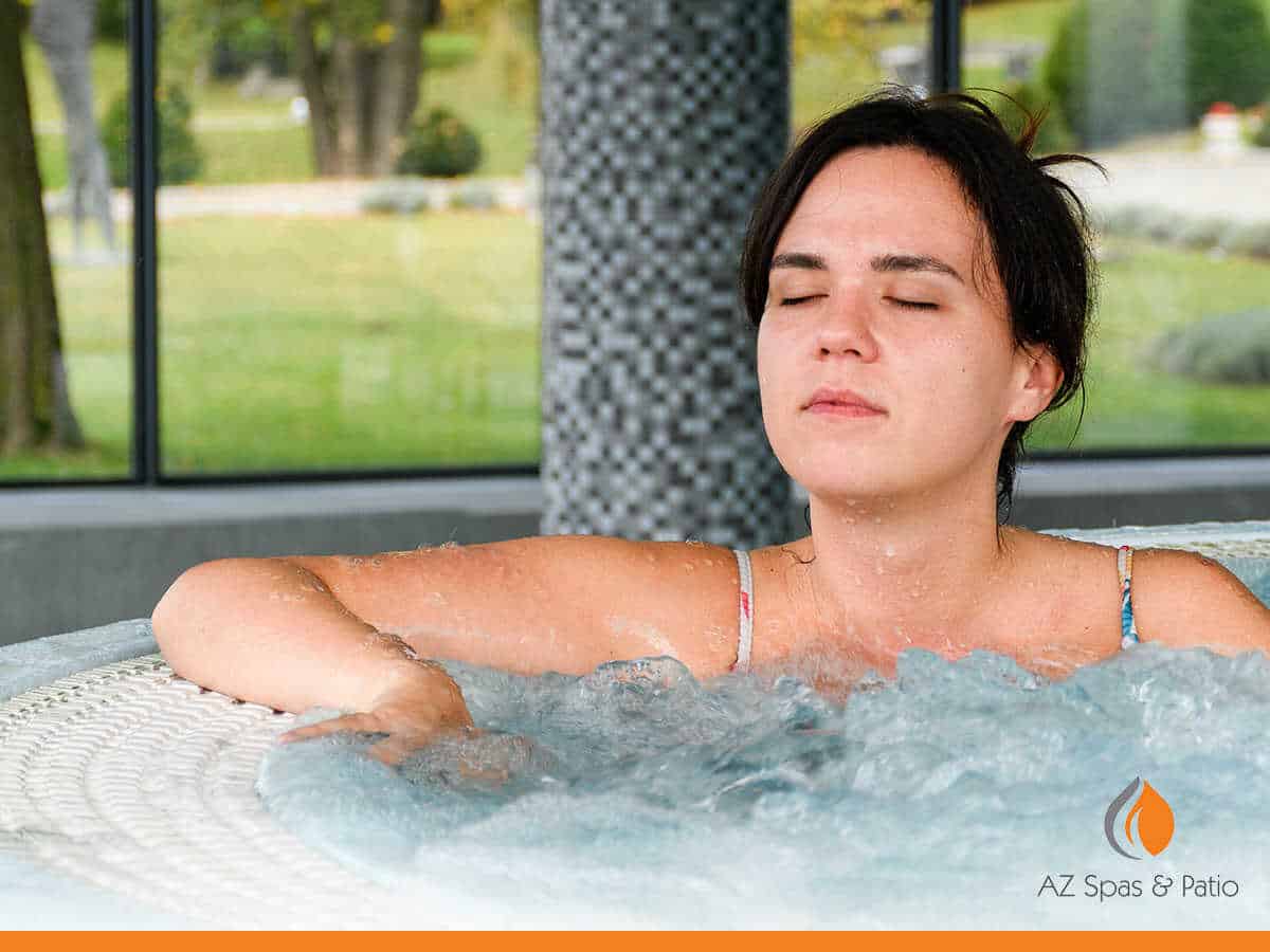 A beautiful woman enjoying her home hot tub in Mesa, AZ.