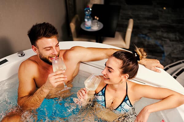Happy Couple Taking a Drink in a Hot Tub in Arizona